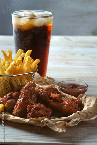 grilled BBQ wings with French fries and Cola