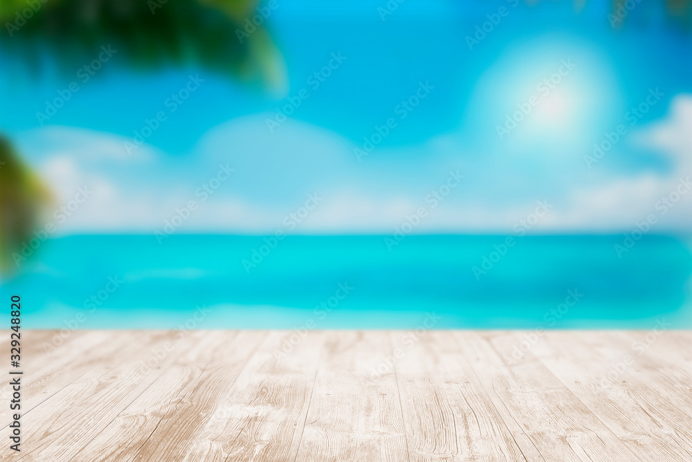 Fototapeta premium Empty wooden terrace on the beach with blurred water and sky. Close-up view with selective focus.
