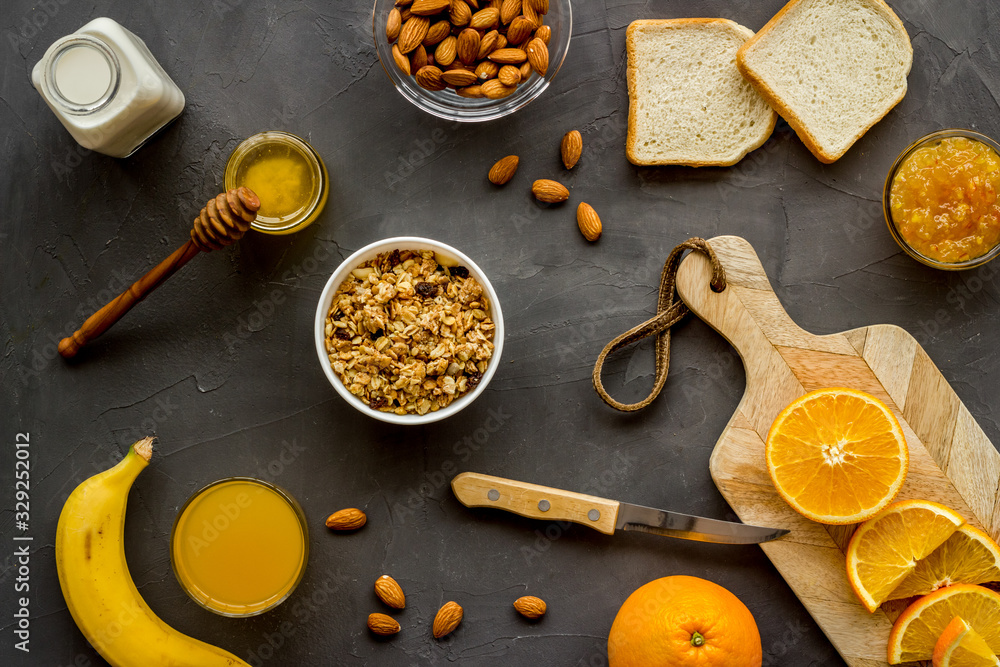 Granola for healthy breakfast. Still life composition with fruits and toast on grey background top-down Granola for healthy breakfast. Still life composition with fruits and toast on grey background top-down