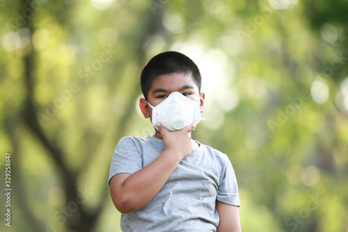 A young Asian boy , 7 Years Old , wear mask to protect against dust PM 2.5 and germs