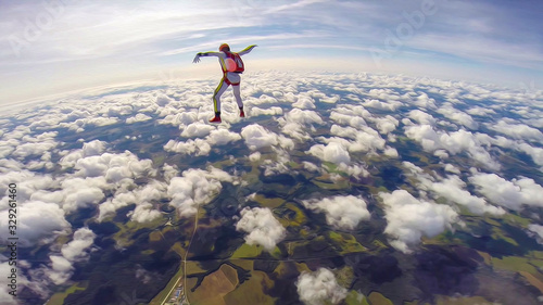 Thinking. Skydiver in free flight. Man among the clouds. Brave people conquer the sky.