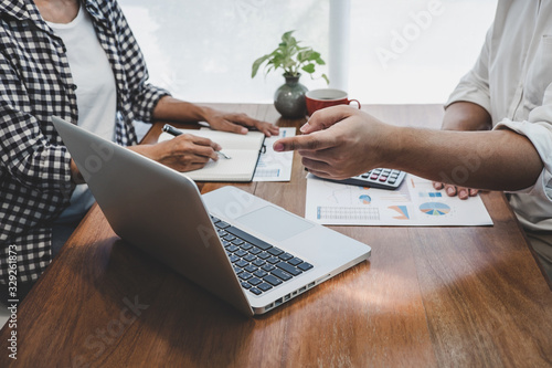 Business team casual collaboration discussing working analysis with financial data and marketing growth report graph in team, Meeting Talking Brainstorming Communication Concept