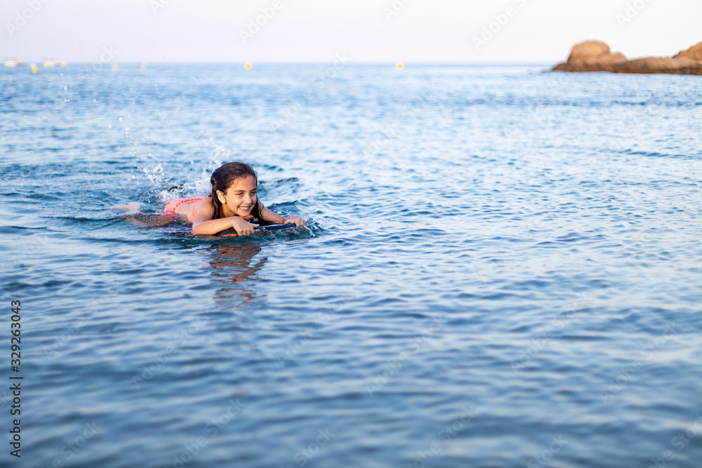 Little child with a bodysurf on the sea