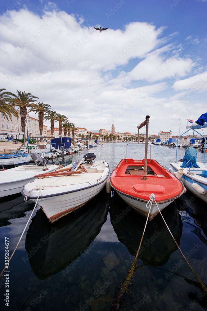 Travel by Croatia. Beautiful landscape with Split Old Town on sea shore. Boats at the harbour.