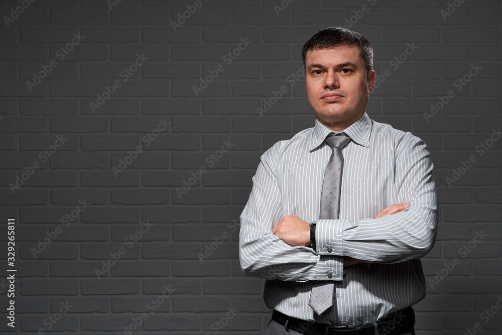 Businessman closeup portrait, dark wall background Businessman closeup portrait, dark wall background