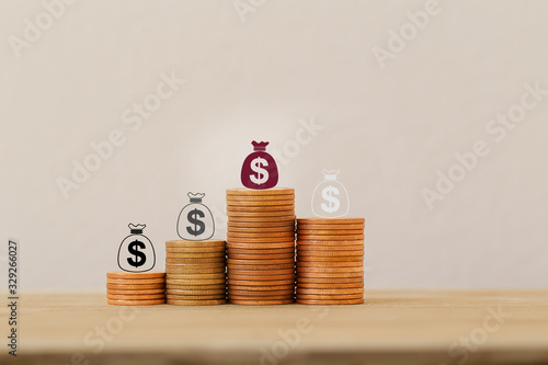 Sustainable fund concepts: Arrange icon US dollar bags on rising coins. Investment in assets from personal income for long-term financial growth. Time value of money, wealth creation