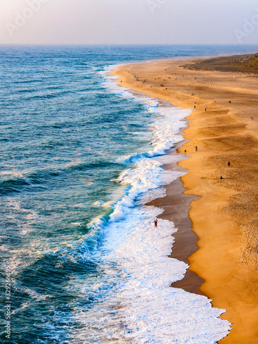Praja do Northe, the wide bay of golden sands of Nazare, Portugal photo