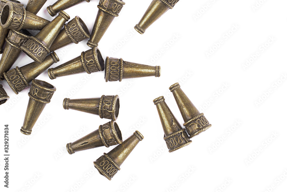 Metal frames for jewelry are scattered on a white background Metal frames for jewelry are scattered on a white background
