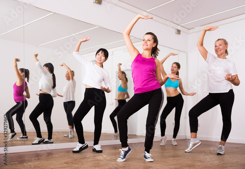 Women dancing aerobics at lesson in the dance class