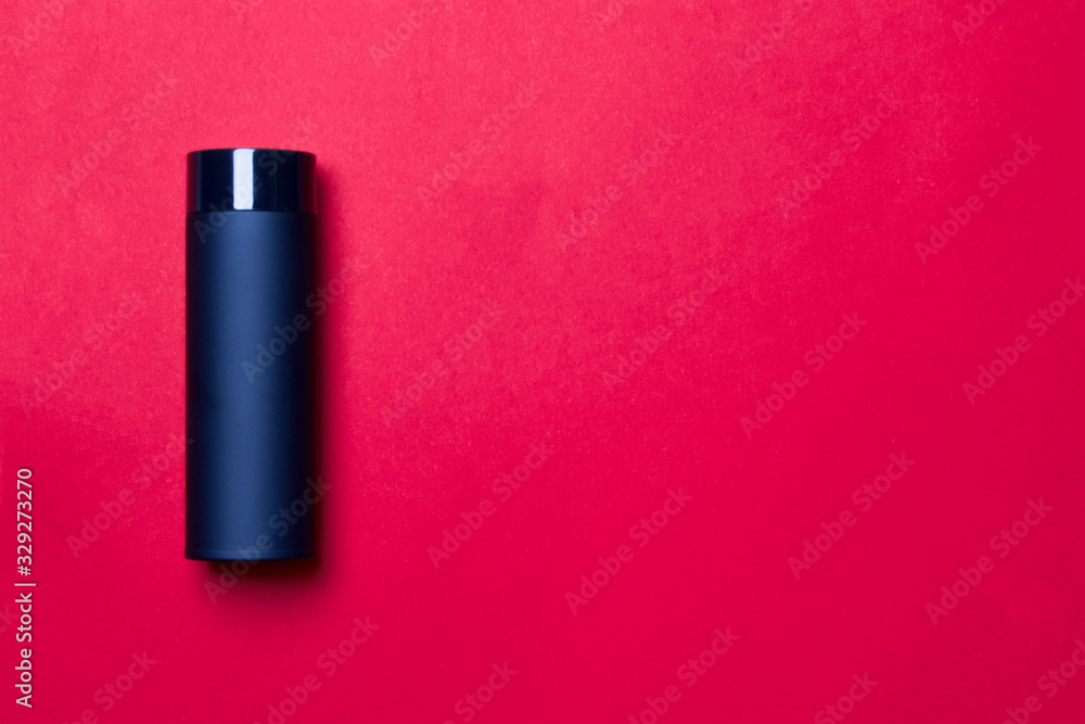 black thermos cup on red background with copy space black thermos cup on red background with copy space