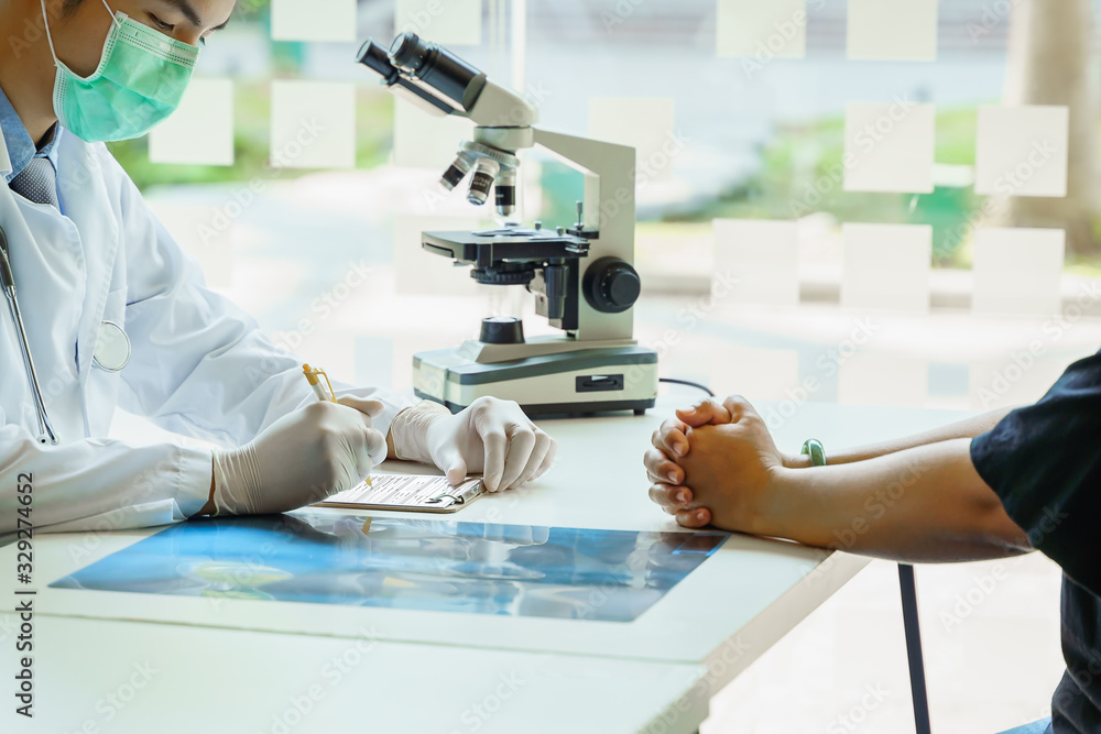Scientist, Microbiologist or Doctor checking examining viral infection or pneumonia lesion on Chest X-ray film in laboratory for analysis and sampling of Coronavirus 2019,COVID-19, nCoV 2019 Scientist, Microbiologist or Doctor checking examining viral infection or pneumonia lesion on Chest X-ray film in laboratory for analysis and sampling of Coronavirus 2019,COVID-19, nCoV 2019
