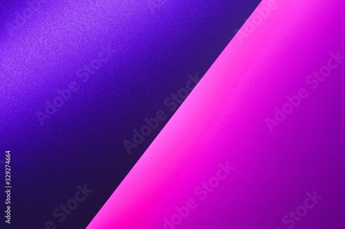 Blank paper sheets rolled in a neon purple lighting close up
