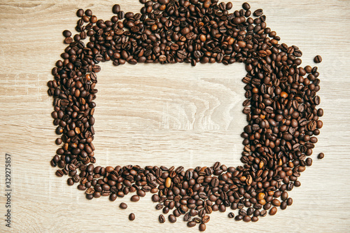 Frame of coffee beans on wood background, copy space