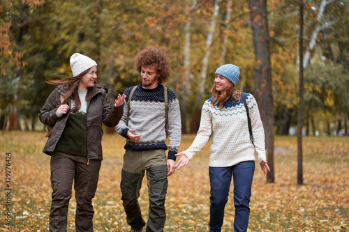 Holidays with friends. Group of young people walking together in the park.