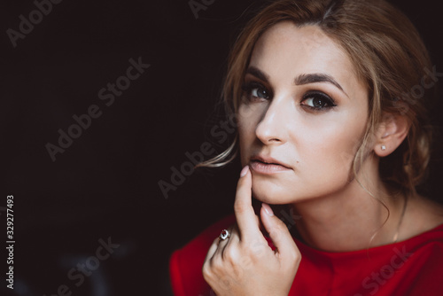 Close-up portrait of a beautiful romantic woman lady in a red dress. Soft selective focus. Beauty  fashion.