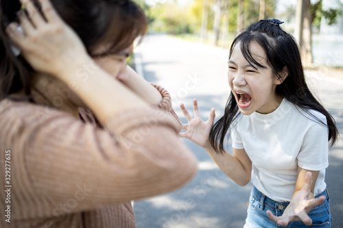 Angry child daughter shouting scolding at her mother about fussy things,nag,stressed girl screaming,girl is going crazy,losing control of emotions,concept of arguing,relationship,family life problems