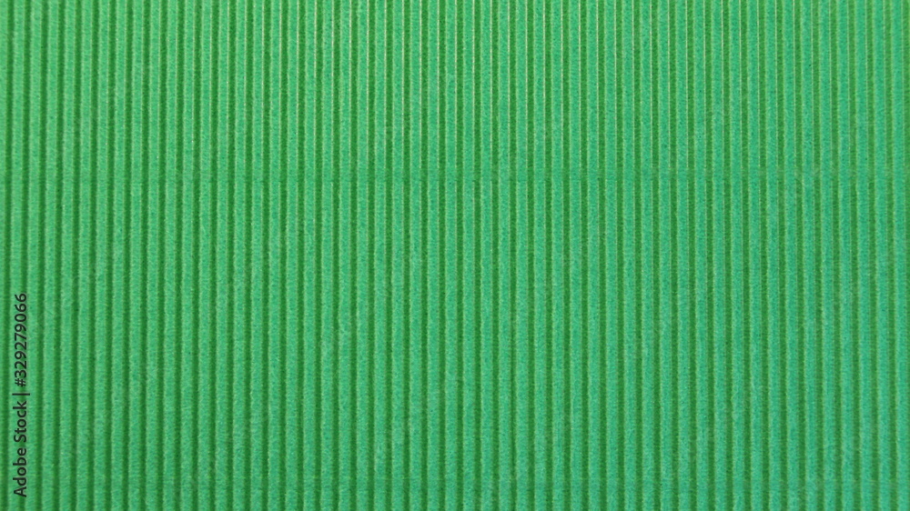 green paper background with embossed vertical stripes green paper background with embossed vertical stripes