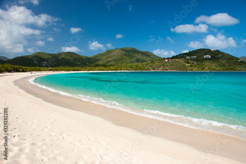 Bright scenic empty view of wide curving Caribbean beach at Long Bay, Beef Island, Tortola, British Virgin Islands