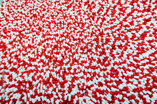  A lot of red and white capsule pills pattern  macro
