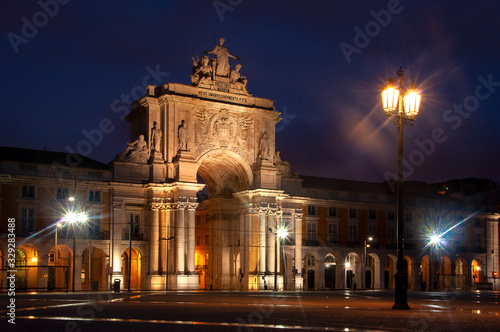 Historical building in Lisbon on Commerce Square, Portugal. Triumphal Rua Augusta Arch. Beautiful night city.
