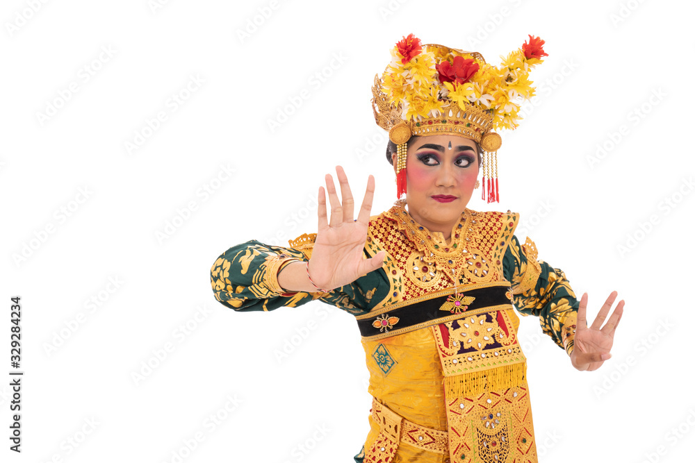 Young women wearing traditional dance clothes are performing movements dancing Balinese