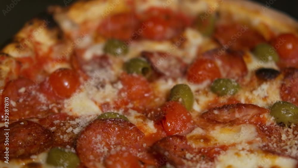 Hands of chef baker in uniform adding pepperoni into pizza. Pizza Art. The process of making pizza. Hands of chef baker in uniform adding pepperoni into pizza. Pizza Art. The process of making pizza.