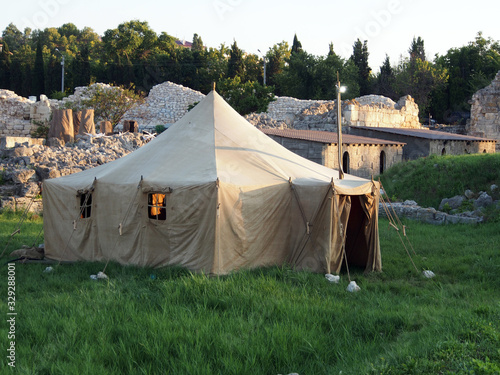 The tent stands on the site of archaeological excavations, against the background of the excavations of the ancient city . Archaeology, study of the past, summer expedition.