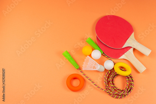 Sport equipment on orange background. © Nikolay