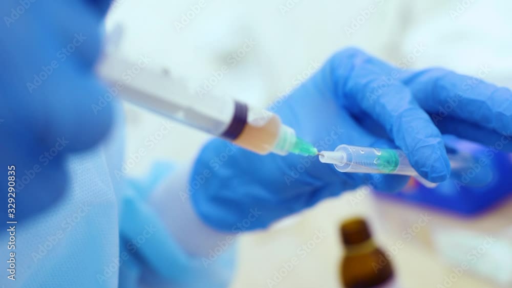 the doctor holds in his hand a syringe with plasma or with a close-up injection for hair regeneration and skin rejuvenation the doctor holds in his hand a syringe with plasma or with a close-up injection for hair regeneration and skin rejuvenation