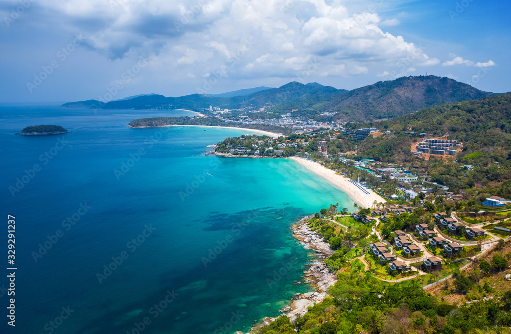 Aerial view of the coastline of Phuket island with tropical sandy beaches and mountains at sunny day, Thailand