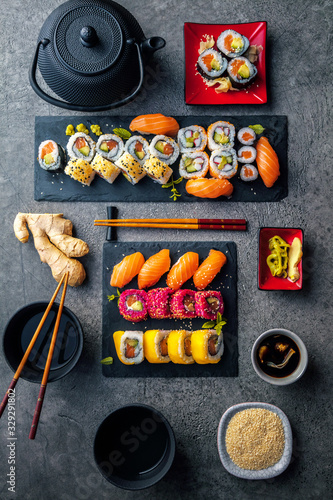 apanese sushi food. Maki ands rolls with tuna, salmon, shrimp, crab and avocado. Top view of assorted sushi. Rainbow sushi roll, uramaki, hosomaki and nigiri