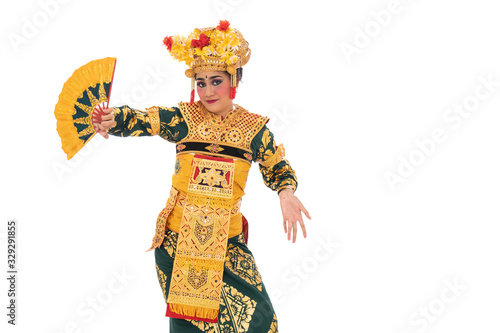 Balinese dancers hold a fan, traditional Indonesia dance culture costume