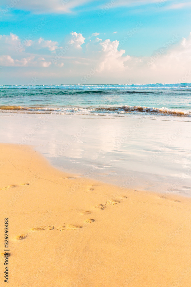 Tropical sea shore. Blue sky, wavy ocean and sandy beach. Warm evening sunlight toned. Sri-Lanka island. Tropical sea shore. Blue sky, wavy ocean and sandy beach. Warm evening sunlight toned. Sri-Lanka island.