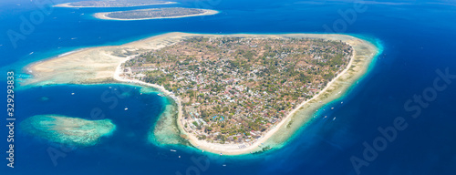 Panoramic aerial view of a beautiful tropical island surrounded by coral reef (Gili Air, Indonesia) photo