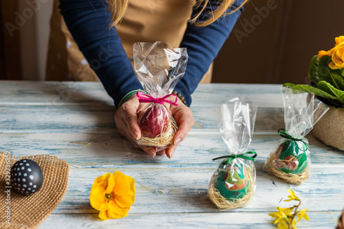 Billede på lærred Woman holding wrapped easter eggs as gift for Easter holiday celebration