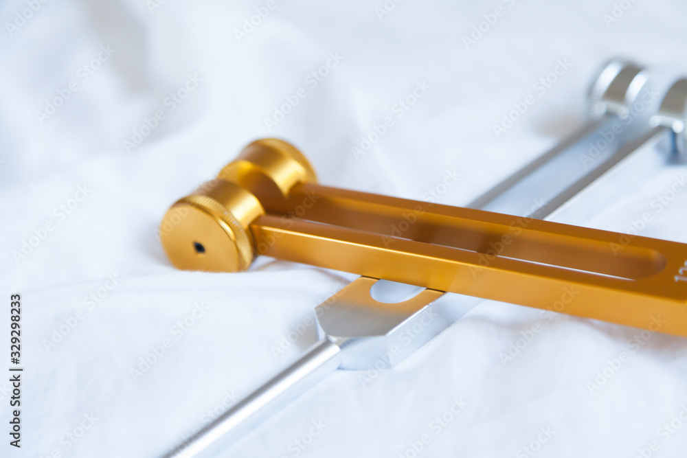 Fotografie Hand holding a tuning fork and crystal stone  .