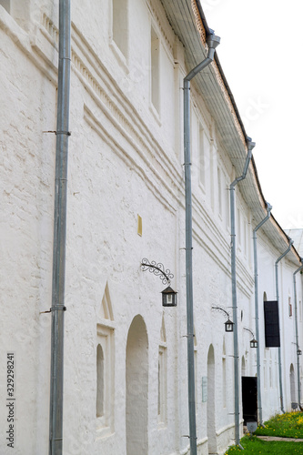 Fototapeta Naklejka Na Ścianę i Meble -  White wall of stone building and lantern. Beautiful tourist view of old city