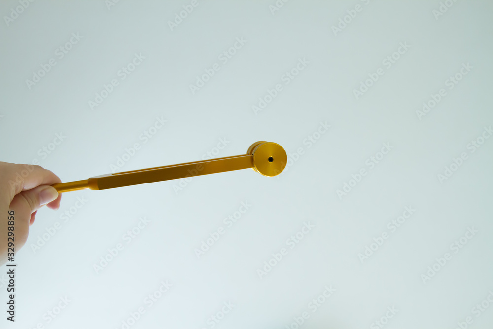 Hand holding a tuning fork and crystal stone . Hand holding a tuning fork and crystal stone .