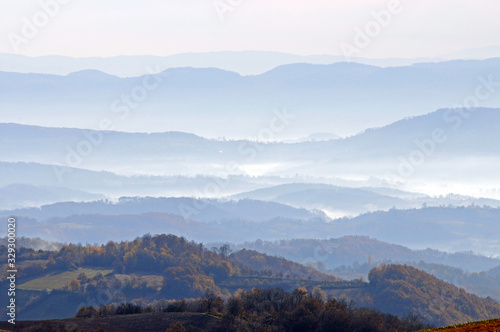  Distant hills in the haze. Beautiful mountain scenery. Mystical rural scenes. Scattered houses of mountain villages. Beautiful nature background.