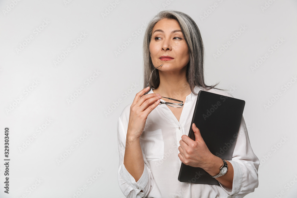 Image of adult mature woman wearing office clothes holding clipboard Image of adult mature woman wearing office clothes holding clipboard