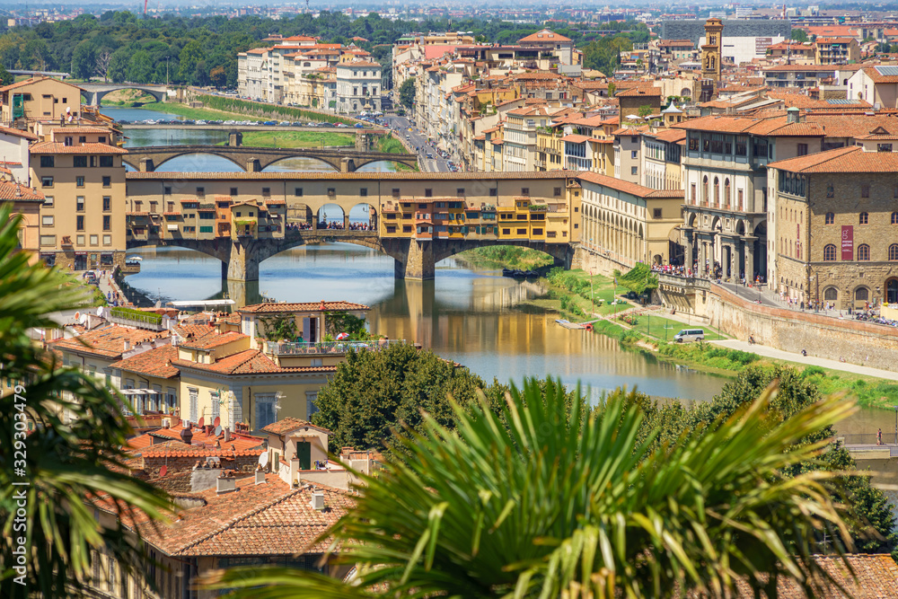 Beautiful wide angle view of the Florence bridges over Arno river in hot summer day. Travel destination Tuscany, Italy