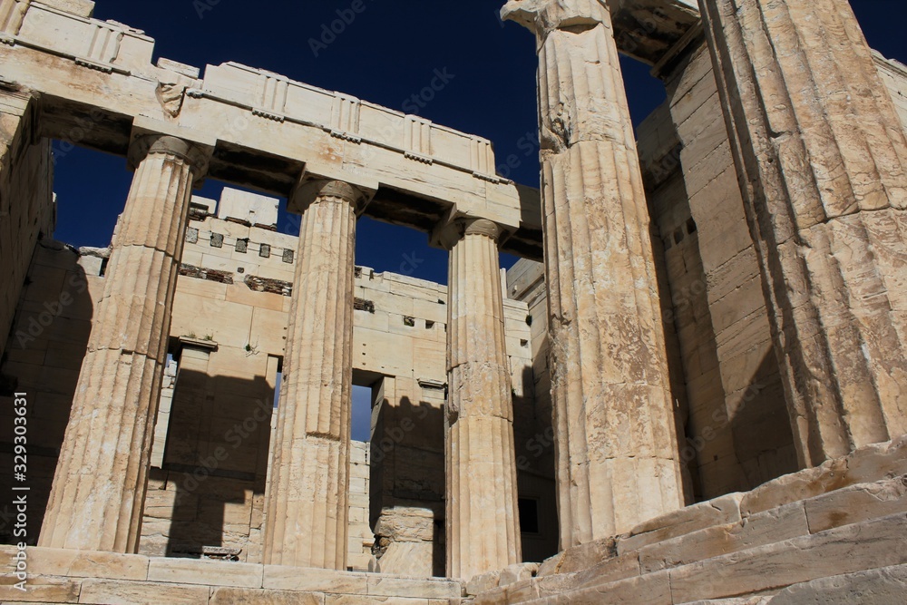 Obraz premium Ancient columns of Propylaea gateway on the Acropolis hill in Athens, Greece.
