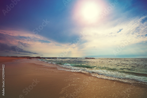 Seascape in the evening. Sunset on the beach. Sandy seashore with beautuful sky