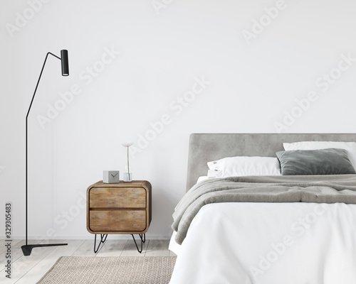 Bright bedroom with a wooden bedside table and a stylish floor lamp photo