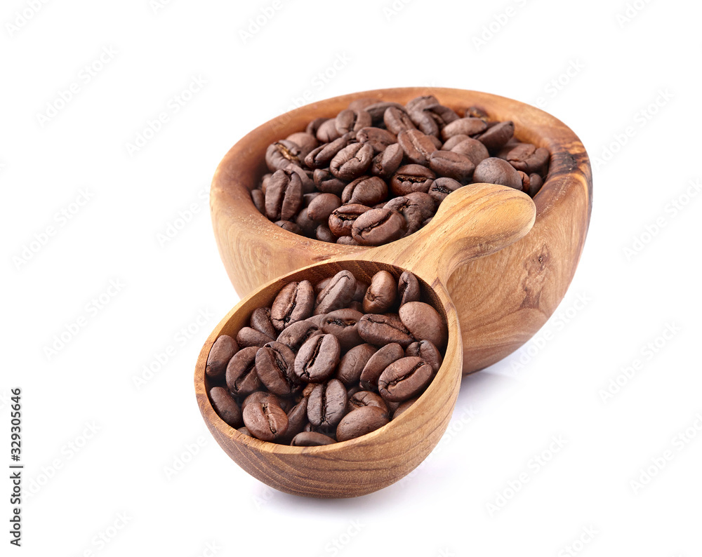 Fototapeta premium Coffee beans in a wooden spoon on white background.