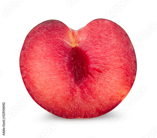 Red plum cut in half isolated on white background. Fresh plum clipping path.