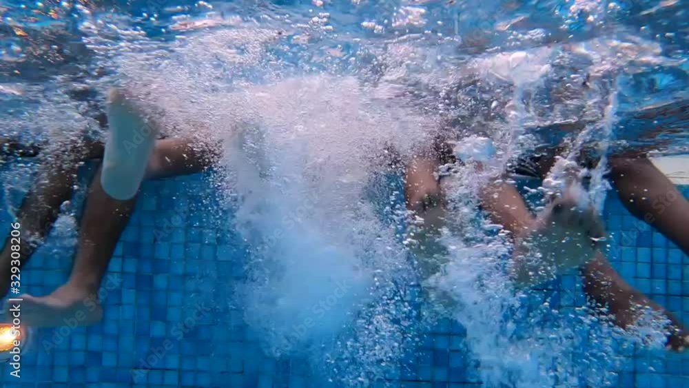 Feet of a group of friends in the pool Feet of a group of friends in the pool