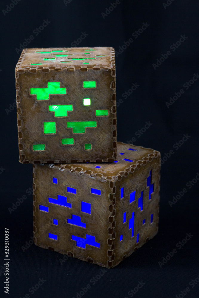 Fototapeta premium Minecraft cubes made of plastic. Two brown minecraft cubes with glowing Windows