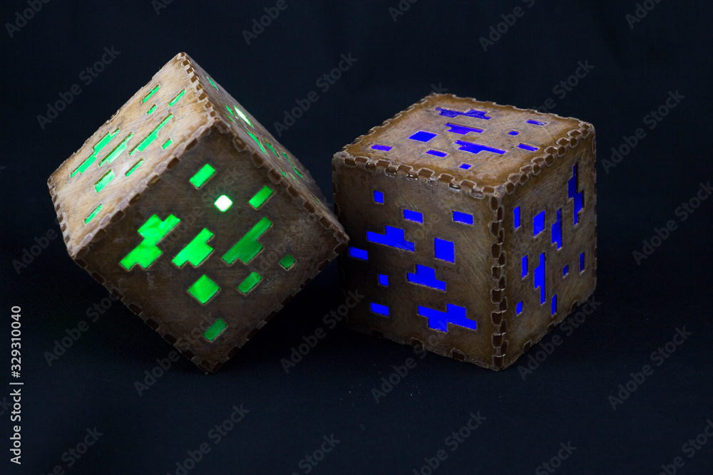 Fototapeta premium Minecraft cubes made of plastic. Two brown minecraft cubes with glowing Windows
