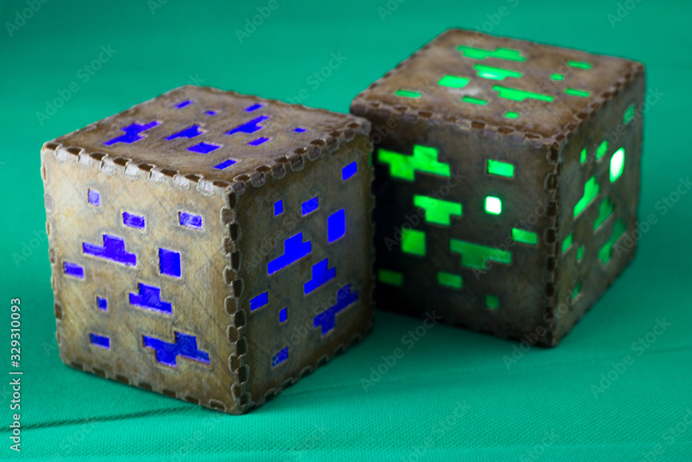Naklejka premium Minecraft cubes made of plastic. Two brown minecraft cubes with glowing Windows